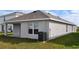 Exterior view of the back of the home, featuring a covered patio and well maintained yard at 3278 Rock Sound St, Bradenton, FL 34208