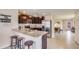 Eat-in kitchen featuring breakfast bar with seating, stainless steel appliances, and dark cabinets at 3278 Rock Sound St, Bradenton, FL 34208