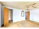 Bedroom with a ceiling fan, mirror, and access to a patio at 3303 Cambridge W Dr, Bradenton, FL 34205