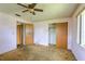 A bedroom with windows, a ceiling fan, a closet, and doors at 3303 Cambridge W Dr, Bradenton, FL 34205