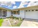 Single-story home with attached garage, walkway, and small garden area at 3303 Cambridge W Dr, Bradenton, FL 34205