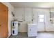 Functional garage area featuring a water heater and laundry setup at 3303 Cambridge W Dr, Bradenton, FL 34205