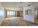 Living room with a kitchen pass-through and a view of the front yard from the window at 3303 Cambridge W Dr, Bradenton, FL 34205