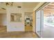 Living room showcasing a pass-through window to the kitchen and sliding glass doors at 3303 Cambridge W Dr, Bradenton, FL 34205