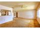 Bright living room featuring a ceiling fan, window, and view into kitchen area at 3303 Cambridge W Dr, Bradenton, FL 34205