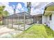 The back of the house shows a screened-in pool, with patio and a grassy yard at 3303 Cambridge W Dr, Bradenton, FL 34205