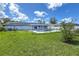 The sprawling backyard has a refreshing pool and sunny lawn at 3339 Duar Ter, North Port, FL 34291
