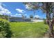 Spacious backyard featuring a well-kept lawn, refreshing swimming pool, and sleek solar panels at 3339 Duar Ter, North Port, FL 34291