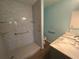 Accessible bathroom with a step-in shower and safety grab bars at 3339 Duar Ter, North Port, FL 34291