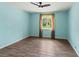 Light filled bedroom with wood look flooring and a large window with beautiful views at 3339 Duar Ter, North Port, FL 34291
