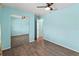 Bedroom with wood-look floors, mirrored closet doors and ceiling fan at 3339 Duar Ter, North Port, FL 34291