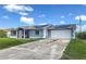 Charming single-story home with a well-maintained lawn, screened-in front porch, and solar panels at 3339 Duar Ter, North Port, FL 34291