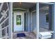 View of the front door of a home that features a secured screen door, a porch, and glass features at 3339 Duar Ter, North Port, FL 34291