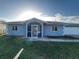 Charming single-story home with a screened front porch and well-maintained lawn at 3339 Duar Ter, North Port, FL 34291