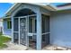 A close-up of the home's front porch featuring a secure screen door and classic architecture at 3339 Duar Ter, North Port, FL 34291