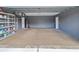 Spacious two car garage with gray block walls and ample storage with shelving and room for your cars or a work space at 3339 Duar Ter, North Port, FL 34291