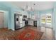 Bright kitchen with white cabinetry, stainless appliances, and sliding doors for outdoor access at 3339 Duar Ter, North Port, FL 34291
