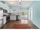 Updated kitchen with stainless appliances, white cabinets, and sliding glass doors to a pool at 3339 Duar Ter, North Port, FL 34291
