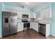 Kitchen with stainless appliances, white cabinets, subway tile backsplash and wood look flooring at 3339 Duar Ter, North Port, FL 34291