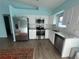 Modern kitchen featuring stainless steel appliances, white cabinets, and tile backsplash at 3339 Duar Ter, North Port, FL 34291