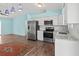 Bright kitchen with stainless appliances, white cabinets, and modern finishes at 3339 Duar Ter, North Port, FL 34291