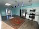 Open concept kitchen with stainless steel appliances flowing into the light-filled living area at 3339 Duar Ter, North Port, FL 34291