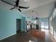 Bright living room with tile floors, a modern ceiling fan, and a view of the kitchen at 3339 Duar Ter, North Port, FL 34291