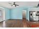 Bright living room with wood floors connects to an open kitchen with stainless appliances at 3339 Duar Ter, North Port, FL 34291