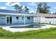 The refreshing pool has a white surround and tile accents at 3339 Duar Ter, North Port, FL 34291