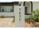 Close up of house numbers on a post surrounded by landscaping at this cozy, modern home at 3631 Palm Dr, Punta Gorda, FL 33950