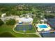 Aerial view of the community featuring a clubhouse, pool, tennis courts, and green spaces for outdoor enjoyment at 3634 Torrey Pines Way Way, Sarasota, FL 34238