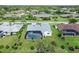 Aerial view of the property with screened pool, lush landscaping, and neighborhood at 3634 Torrey Pines Way Way, Sarasota, FL 34238