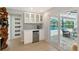 Bar area with wine cooler, cabinetry, and glassware storage located off of the pool deck at 3634 Torrey Pines Way Way, Sarasota, FL 34238