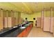 Bright bathroom featuring multiple stalls, sinks, black granite counters, large mirrors, and ample lighting at 3634 Torrey Pines Way Way, Sarasota, FL 34238