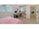 Bright bedroom has laminate floors and a mirrored closet along with a desk at 3634 Torrey Pines Way Way, Sarasota, FL 34238