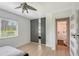 Bright bedroom with a window, ceiling fan and modern wardrobe with mirrored door at 3634 Torrey Pines Way Way, Sarasota, FL 34238