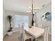 Bright dining room with modern lighting fixture, white table, and views of the neighborhood at 3634 Torrey Pines Way Way, Sarasota, FL 34238