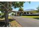 Exterior of building featuring a palm tree, well-manicured lawns and a paved driveway at 3634 Torrey Pines Way Way, Sarasota, FL 34238