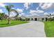Beautiful one-story home with a paved driveway, black and white exterior paint and landscaping at 3634 Torrey Pines Way Way, Sarasota, FL 34238
