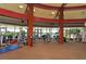 Well-equipped gym with various exercise machines, carpeted flooring, and natural light streaming through expansive windows at 3634 Torrey Pines Way Way, Sarasota, FL 34238