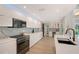 Modern kitchen featuring an island with stainless steel appliances, black fixtures, and lots of counter space at 3634 Torrey Pines Way Way, Sarasota, FL 34238