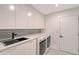 Contemporary laundry room with new appliances, sleek countertops and ample cabinet space at 3634 Torrey Pines Way Way, Sarasota, FL 34238
