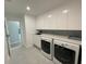 Modern laundry room with ample cabinet space, sink, and sleek countertops, designed for convenience at 3634 Torrey Pines Way Way, Sarasota, FL 34238