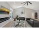 Open concept living room with modern fireplace, high ceilings, and comfortable leather seating at 3634 Torrey Pines Way Way, Sarasota, FL 34238