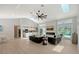 A bright living room with a modern fireplace and a view of the pool at 3634 Torrey Pines Way Way, Sarasota, FL 34238