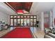 Lobby featuring a red carpet, comfortable seating, wood paneled doors and an elegant chandelier at 3634 Torrey Pines Way Way, Sarasota, FL 34238