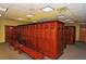 Spacious locker room featuring wood lockers, seating benches, carpeted flooring, and a tiled ceiling at 3634 Torrey Pines Way Way, Sarasota, FL 34238