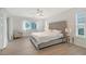 Bright main bedroom with decorative headboard, ceiling fan, and access to the backyard at 3634 Torrey Pines Way Way, Sarasota, FL 34238