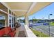 Expansive patio overlooking a swimming pool and tennis courts, furnished with comfortable seating at 3634 Torrey Pines Way Way, Sarasota, FL 34238