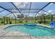 Screened-in pool with a spa and view of the lush green golf course at 3634 Torrey Pines Way Way, Sarasota, FL 34238